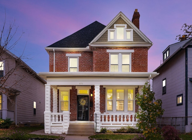 870 Oakwood Ave, Columbus, OH 43206 - view of front of home featuring brick siding, a porch, a chimney, and a shingled roof