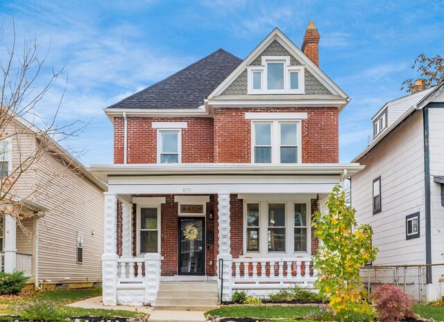 870 Oakwood Ave, Columbus, OH 43206 - view of front facade featuring a chimney, a shingled roof, covered porch, fence, and brick siding
