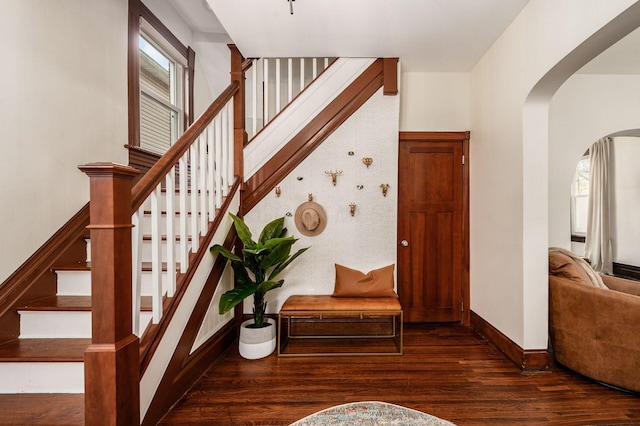 870 Oakwood Ave, Columbus, OH 43206 - stairway featuring arched walkways, wood finished floors, and baseboards