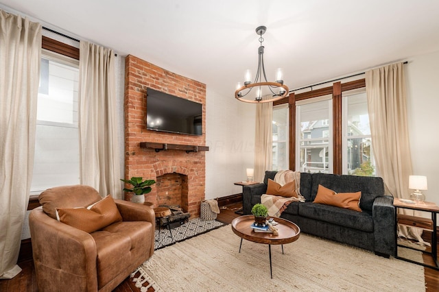 870 Oakwood Ave, Columbus, OH 43206 - living room with a fireplace, a notable chandelier, wood finished floors, and plenty of natural light
