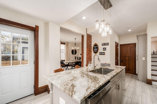 870 Oakwood Ave, Columbus, OH 43206 - kitchen with dishwasher, a wealth of natural light, a sink, and an inviting chandelier