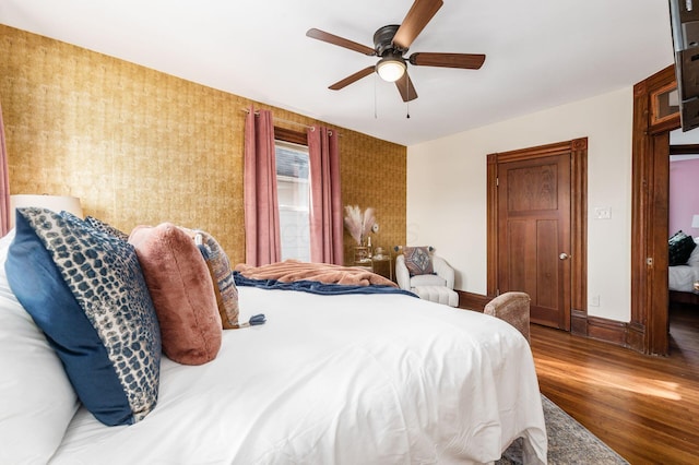 870 Oakwood Ave, Columbus, OH 43206 - bedroom with ceiling fan, baseboards, wood finished floors, and wallpapered walls