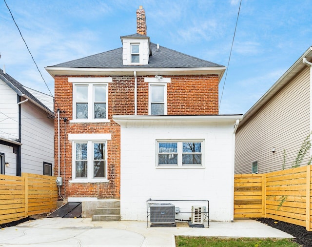 870 Oakwood Ave, Columbus, OH 43206 - back of house with cooling unit, brick siding, a fenced backyard, and roof with shingles
