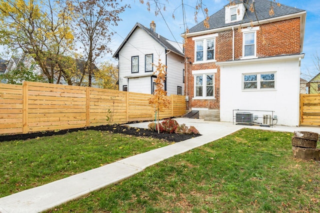 870 Oakwood Ave, Columbus, OH 43206 - back of property featuring a fenced backyard, brick siding, a yard, and a patio
