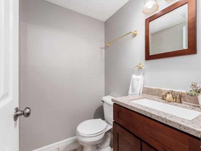 half bath featuring vanity and toilet