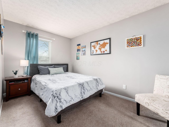 carpeted bedroom featuring a textured ceiling and baseboards