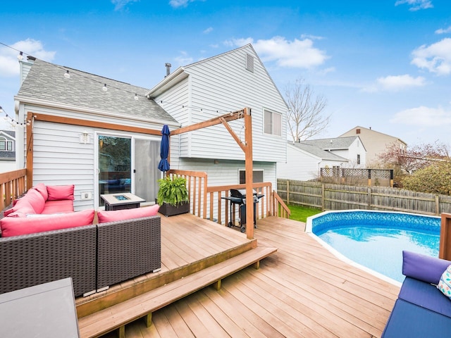 wooden terrace featuring a fenced in pool, an outdoor living space, grilling area, and fence