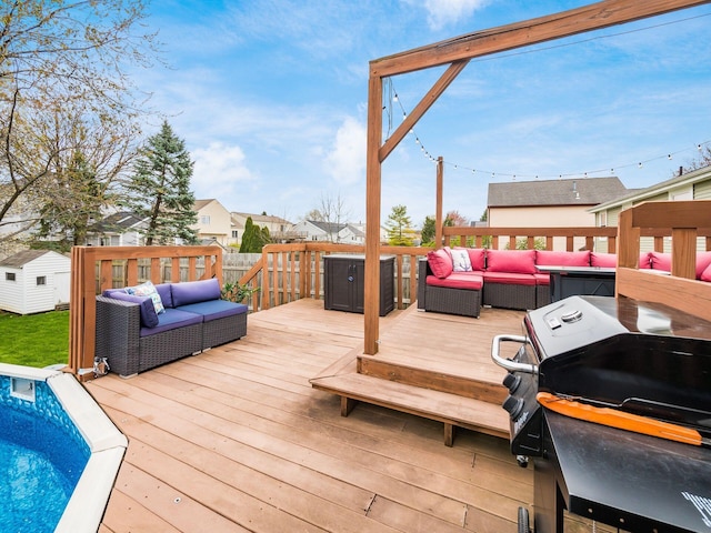 wooden terrace with an outdoor pool, area for grilling, and an outdoor hangout area