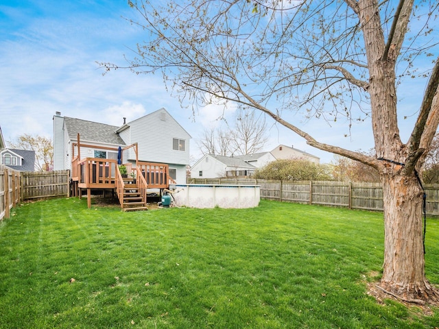 rear view of house with a yard, a fenced backyard, a shingled roof, a fenced in pool, and a deck