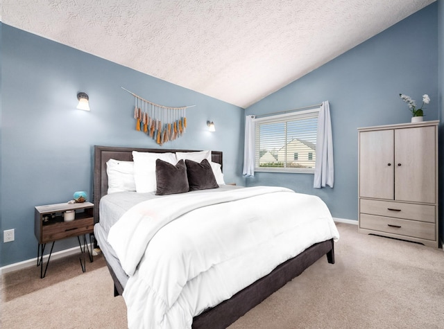 bedroom with baseboards, light colored carpet, a textured ceiling, and lofted ceiling