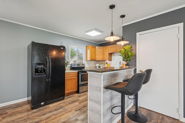 kitchen with wood finished floors, electric stove, ornamental molding, black refrigerator with ice dispenser, and pendant lighting