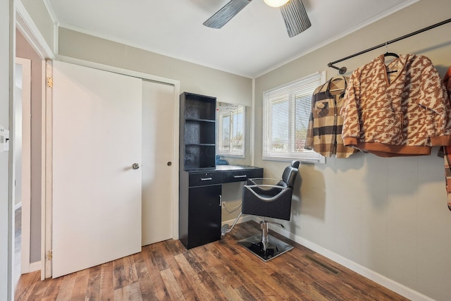 office area with ornamental molding, a ceiling fan, wood finished floors, and visible vents