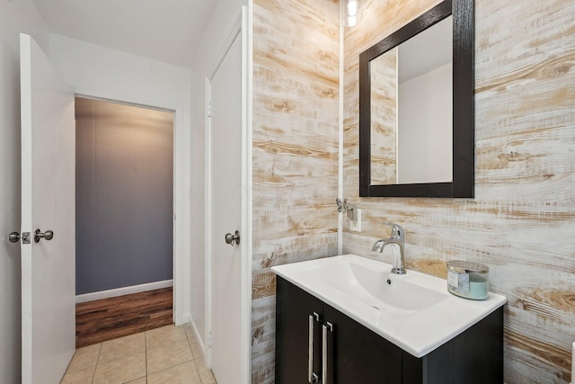 bathroom with baseboards, tile patterned flooring, and vanity