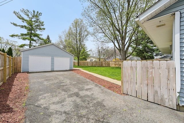 detached garage featuring fence