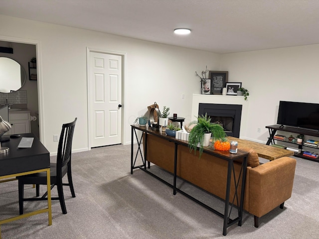 carpeted living room featuring a fireplace