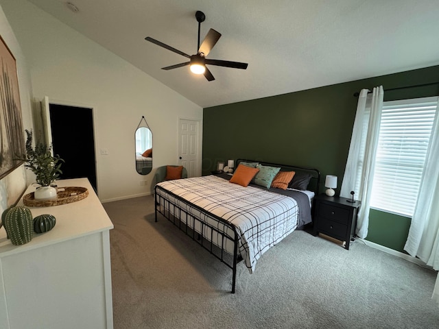 carpeted bedroom featuring high vaulted ceiling, baseboards, and a ceiling fan