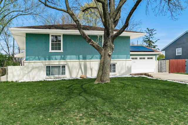 2852 Longfield Rd, Columbus, OH 43204 - view of front of house featuring driveway, stucco siding, a garage, and solar panels
