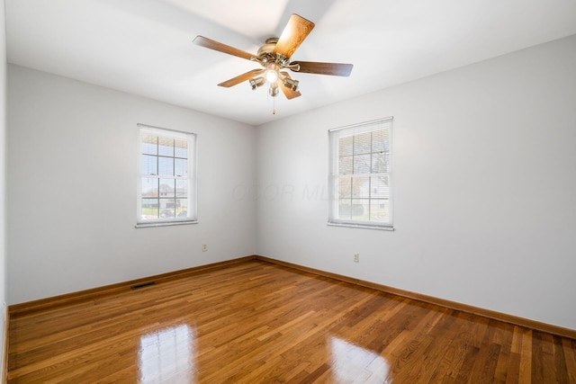 2852 Longfield Rd, Columbus, OH 43204 - spare room featuring wood finished floors, baseboards, and a ceiling fan