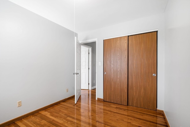 2852 Longfield Rd, Columbus, OH 43204 - unfurnished bedroom featuring wood finished floors, baseboards, and a closet