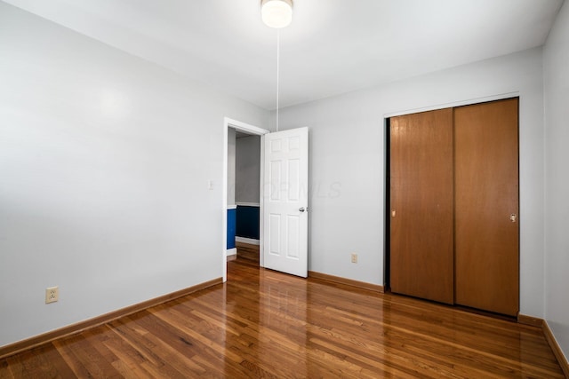 2852 Longfield Rd, Columbus, OH 43204 - unfurnished bedroom with wood finished floors, baseboards, and a closet