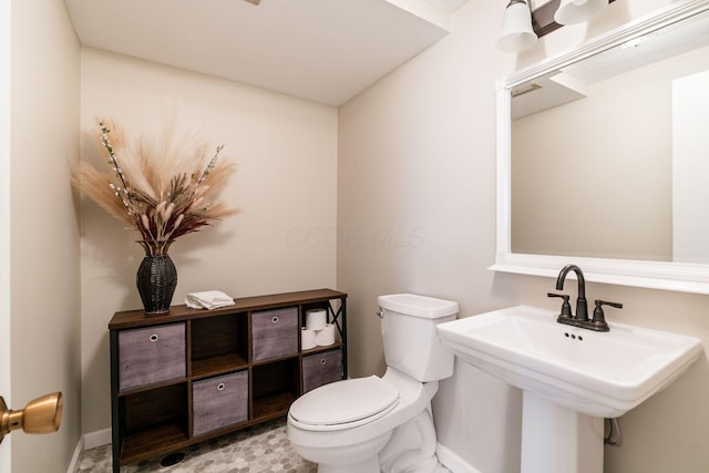 2852 Longfield Rd, Columbus, OH 43204 - bathroom with toilet, baseboards, and a sink