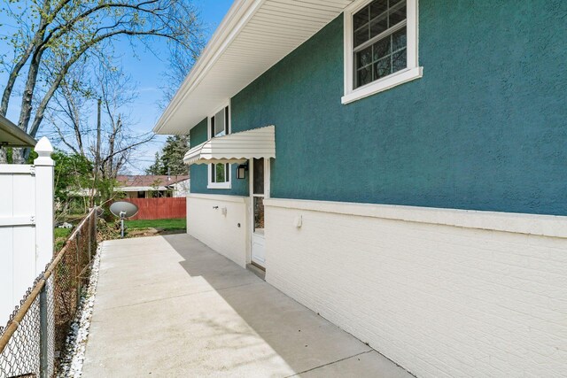 2852 Longfield Rd, Columbus, OH 43204 - view of side of property featuring stucco siding and a patio