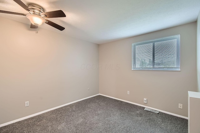 carpeted empty room with a ceiling fan and baseboards
