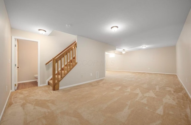 finished basement featuring baseboards, carpet, and stairs