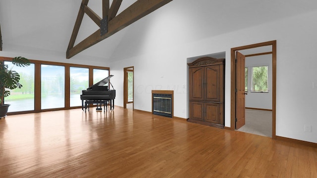 3448 Ostrander Rd, Ostrander, OH 43061 - living area with high vaulted ceiling, a glass covered fireplace, baseboards, wood finished floors, and beam ceiling