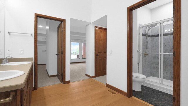 3448 Ostrander Rd, Ostrander, OH 43061 - bathroom featuring a stall shower, wood finished floors, toilet, and baseboards
