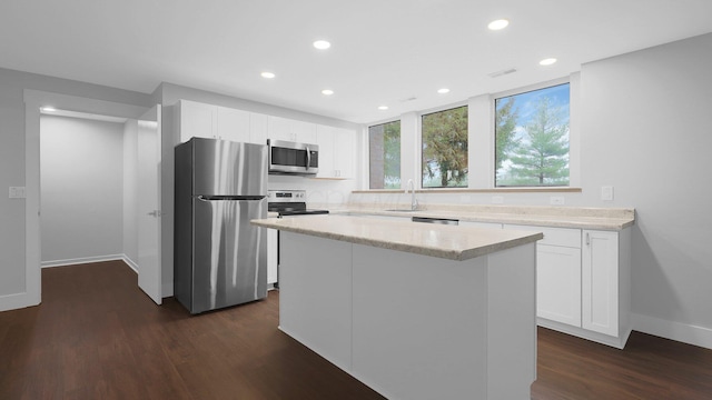 3448 Ostrander Rd, Ostrander, OH 43061 - kitchen with appliances with stainless steel finishes, a sink, recessed lighting, dark wood finished floors, and baseboards