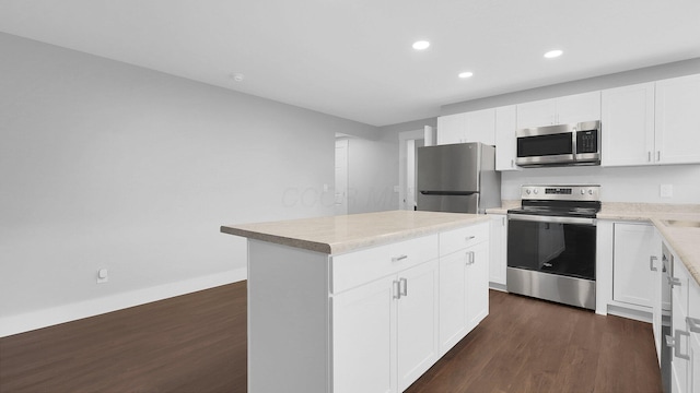 3448 Ostrander Rd, Ostrander, OH 43061 - kitchen with stainless steel appliances, dark wood finished floors, recessed lighting, a kitchen island, and white cabinets