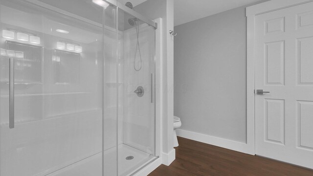 3448 Ostrander Rd, Ostrander, OH 43061 - full bathroom with a stall shower, toilet, wood finished floors, and baseboards
