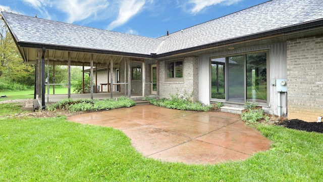 3448 Ostrander Rd, Ostrander, OH 43061 - rear view of property with brick siding, a shingled roof, and a yard