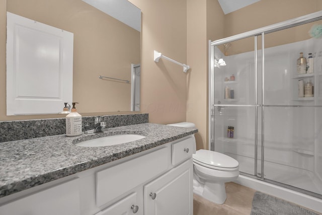 full bath featuring a shower stall, vanity, toilet, and tile patterned flooring