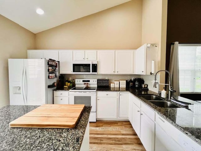 5492 Sentinel Falls St, Dublin, OH 43016 - kitchen with white appliances, a sink, high vaulted ceiling, white cabinets, and dark stone countertops
