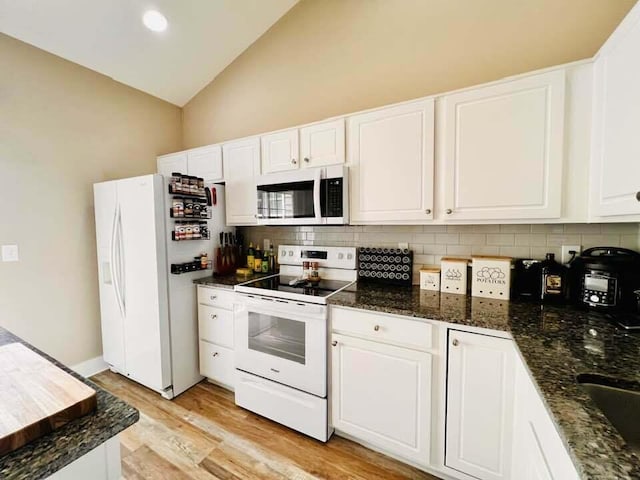 5492 Sentinel Falls St, Dublin, OH 43016 - kitchen featuring white appliances, tasteful backsplash, white cabinets, light wood-style flooring, and high vaulted ceiling