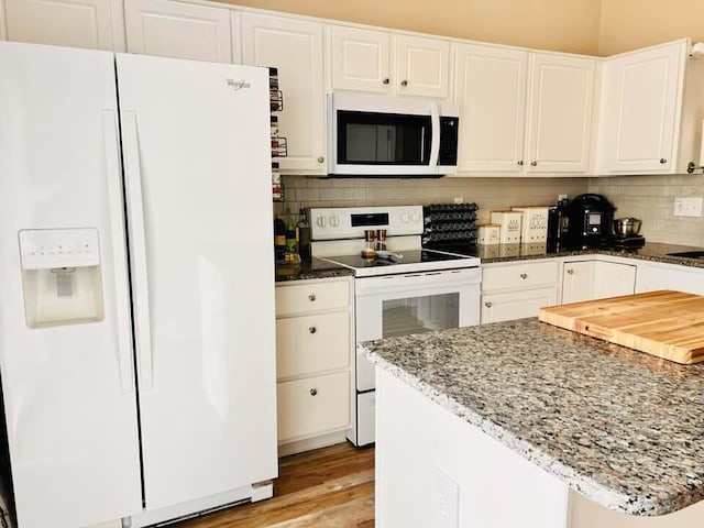 5492 Sentinel Falls St, Dublin, OH 43016 - kitchen featuring white appliances, white cabinetry, dark stone countertops, and tasteful backsplash