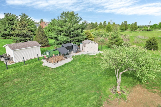 view of yard with fence, an outbuilding, and a shed