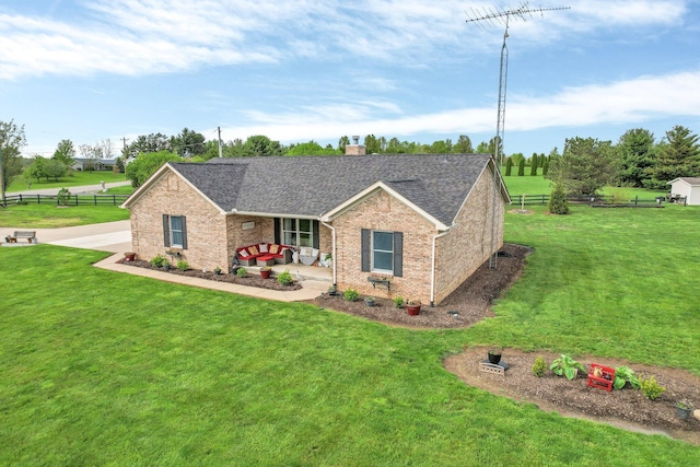 view of front of house featuring a front lawn, fence, covered porch, a chimney, and brick siding