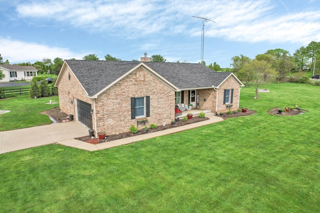 view of front facade with a front lawn, a chimney, brick siding, a shingled roof, and driveway