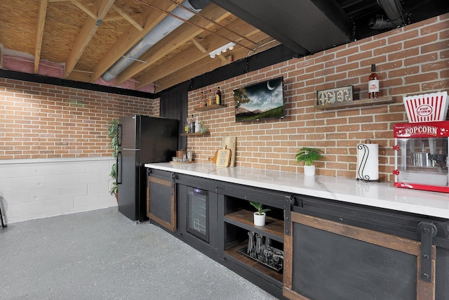 bar with a bar, freestanding refrigerator, and brick wall