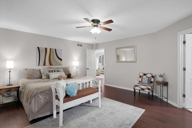 bedroom featuring baseboards, wood finished floors, and visible vents