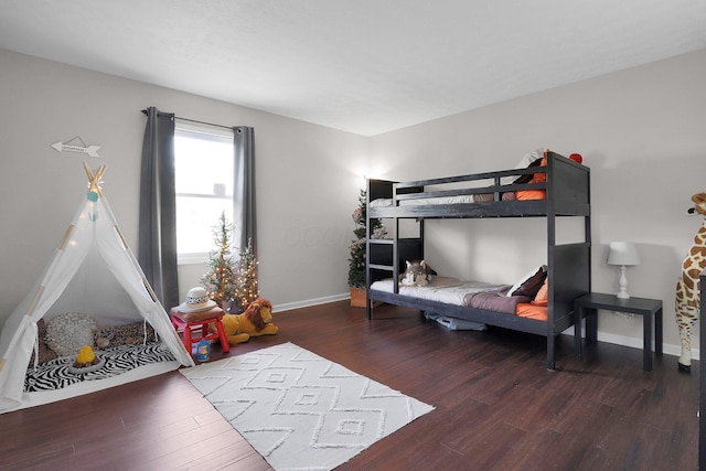 bedroom featuring baseboards and wood finished floors