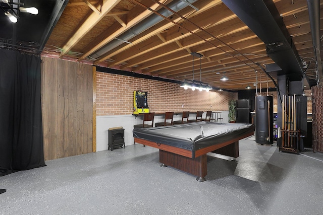 playroom with wooden walls, a wood stove, speckled floor, water heater, and billiards