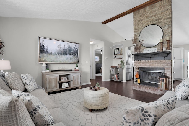 living room featuring lofted ceiling with beams, a brick fireplace, baseboards, wood finished floors, and visible vents