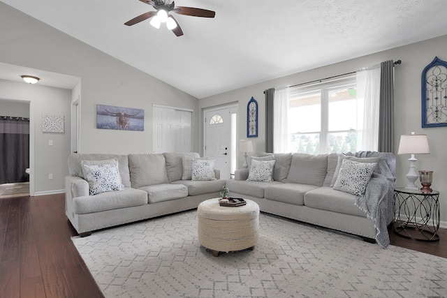 living room featuring baseboards, a ceiling fan, wood finished floors, and lofted ceiling