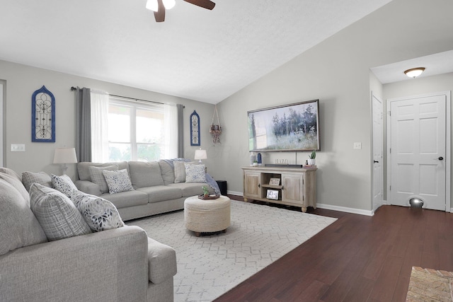 living room with baseboards, a ceiling fan, dark wood-style flooring, and vaulted ceiling