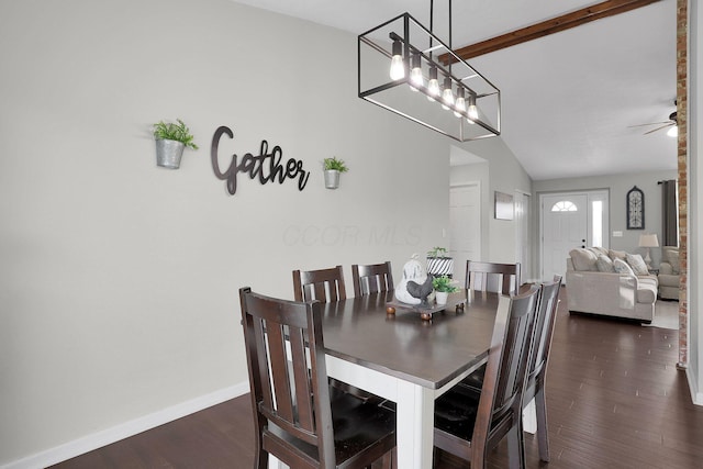dining room featuring baseboards, a ceiling fan, lofted ceiling, and dark wood-type flooring