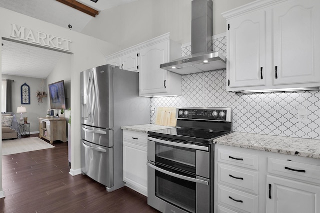 kitchen featuring backsplash, white cabinetry, lofted ceiling with beams, stainless steel appliances, and wall chimney exhaust hood